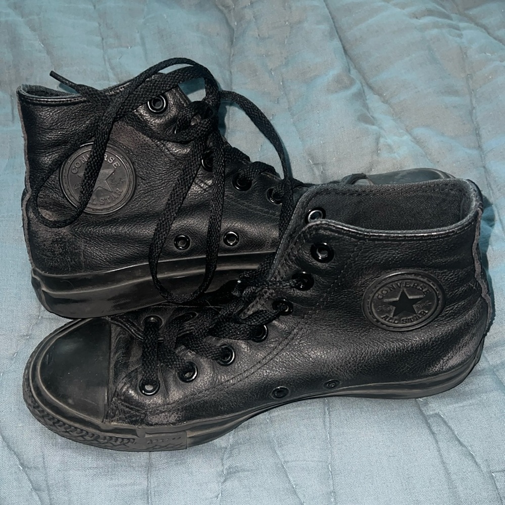 Chuck Taylor All Star Leather high tops in black. Women’s size 6.